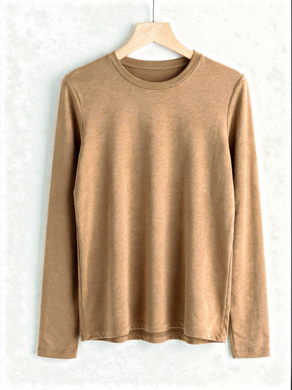 Camel silk blend top with a ribbed crew neck and long sleeves, shown on a wooden hanger