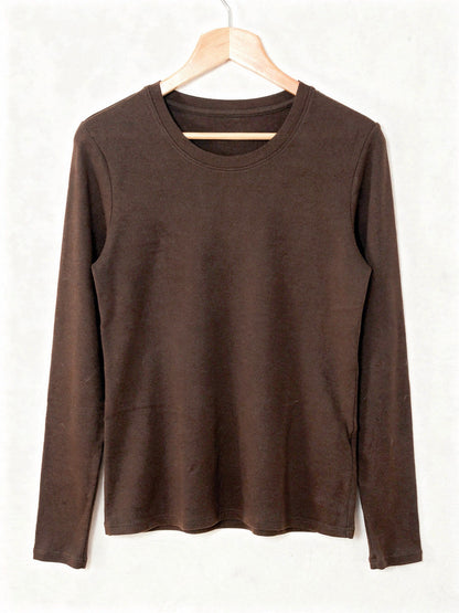 Chocolate silk blend top with a ribbed crew neck and long sleeves, shown on a wooden hanger