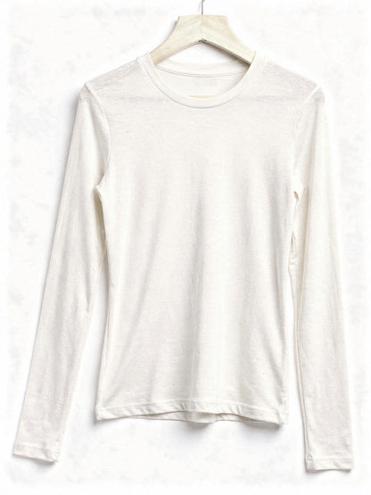 Cream silk blend top with a ribbed crew neck and long sleeves, shown on a wooden hanger