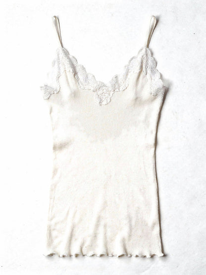 Milk white silk cami in a fine ribbed knit with lace trim, shown flat on white