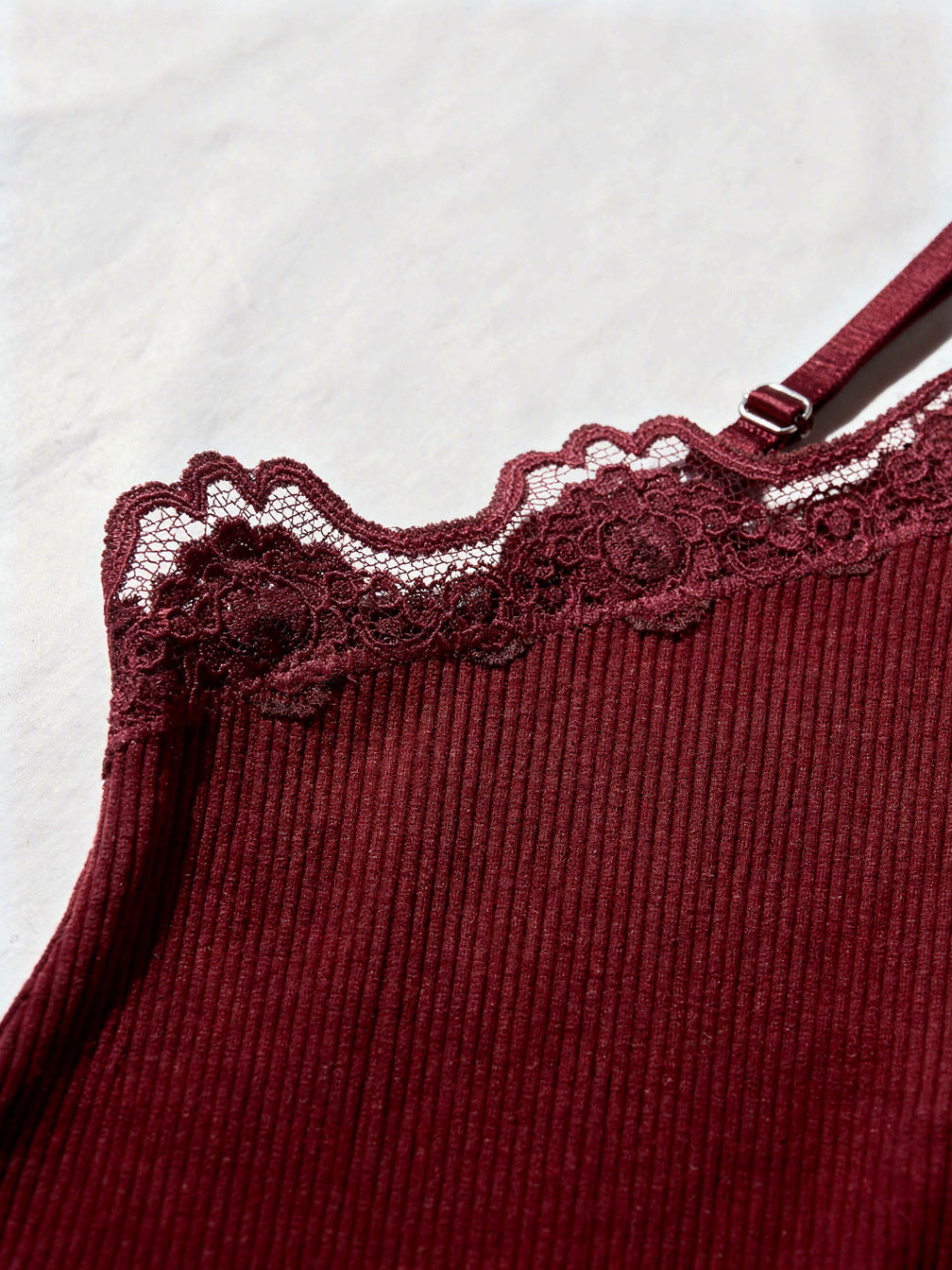 Close-up of the scalloped floral lace trim and fine rib of the claret silk cami