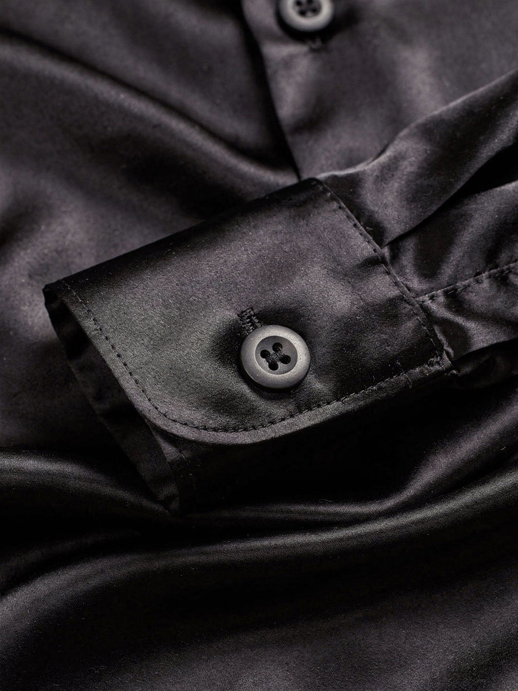 Close up of the black silk cloth and the barrel cuff of the shirt