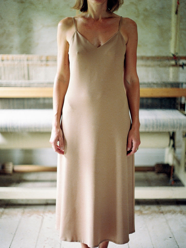 Almond slip dress close view of the V neck, fine straps and matte cloth