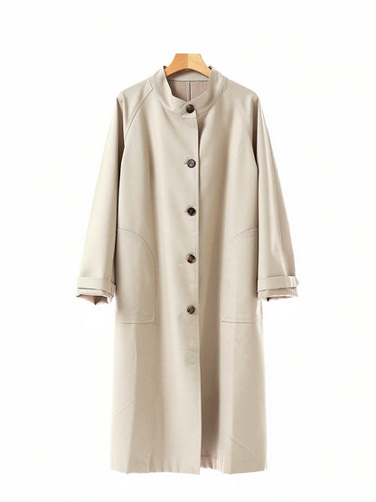 Stand collar coat in Sesame on a hanger, showing the band collar, the five button front and the patch pockets