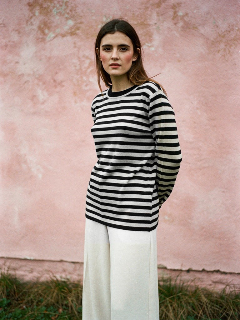 Striped jumper worn in black breton knit with a ribbed crew neck