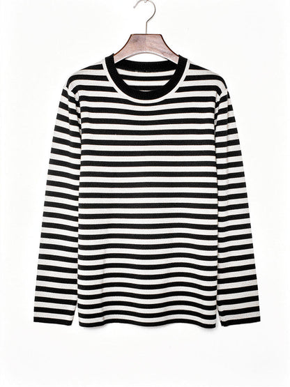 Black striped jumper in fine breton knit shown on a hanger