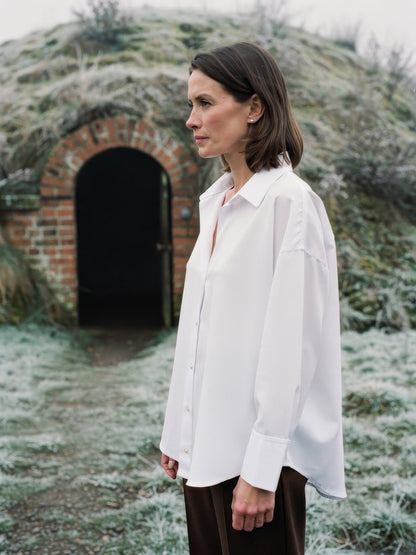 Oversized shirt in bright white worn loose, side view