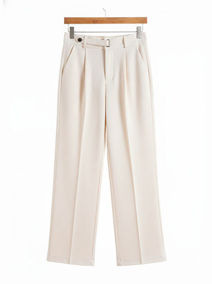 Tailored trousers in Clotted Cream brushed twill shown in full on a wooden hanger