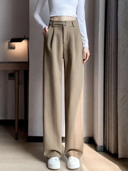 Tailored trousers in Nougat worn full length, breaking over a flat shoe