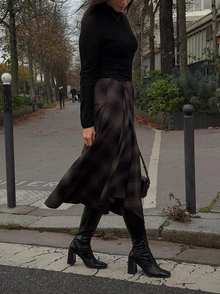 Tartan midi skirt worn walking, supplier photograph showing the swing of the hem