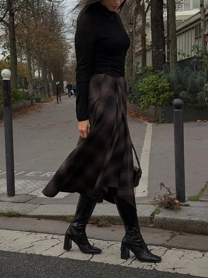 Tartan midi skirt worn walking, supplier photograph showing the swing of the hem