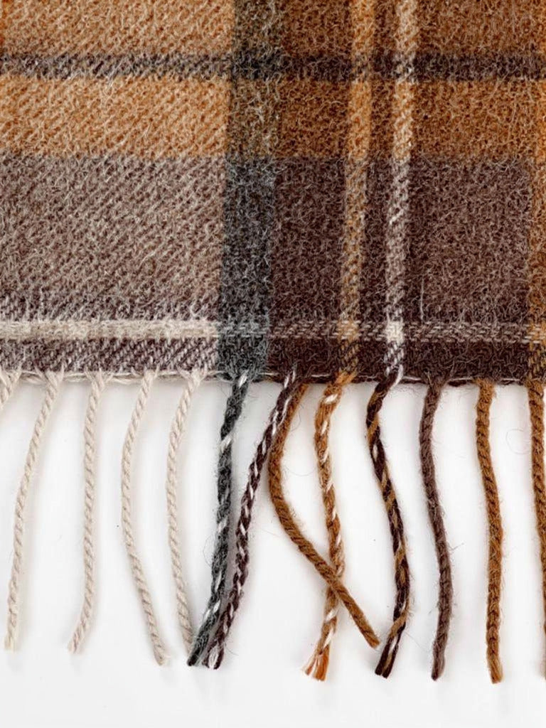 Close up of the brushed wool weave and the twisted tassels of the tartan scarf