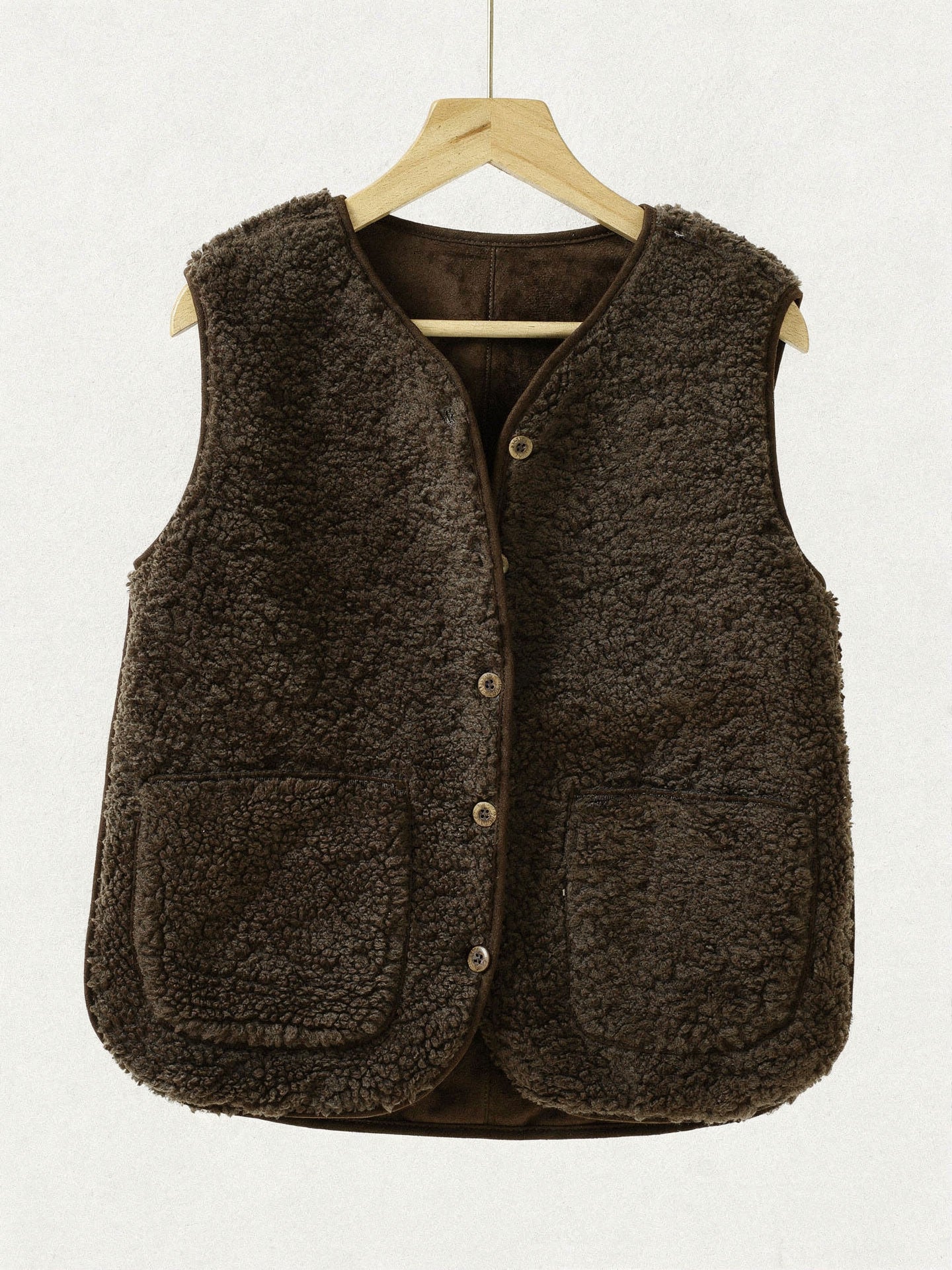 Chocolate brown teddy borg gilet on a wooden hanger, front view