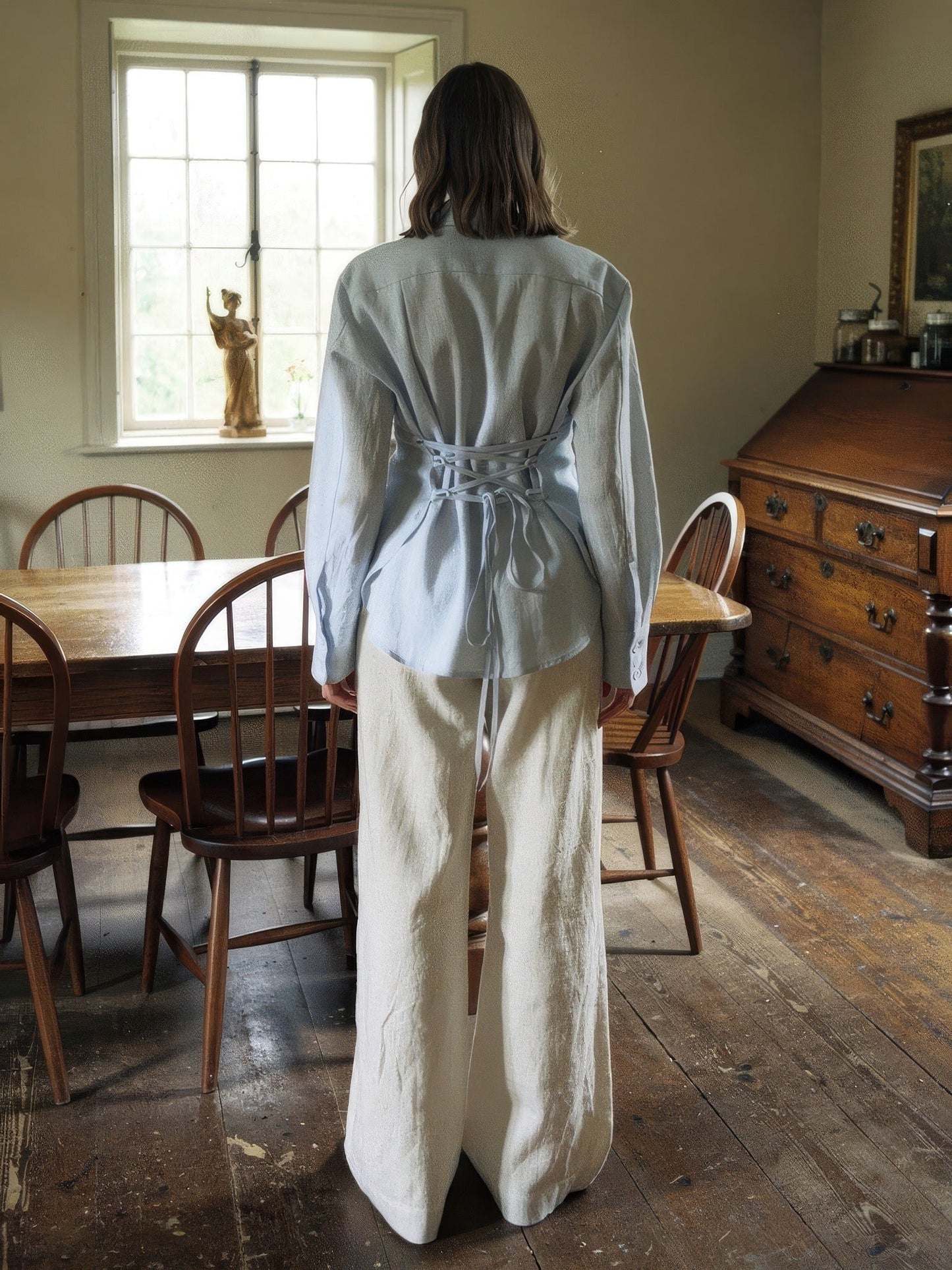 Back of the powder blue tie-waist blouse with the ribbon sash criss crossed and tied at the waist