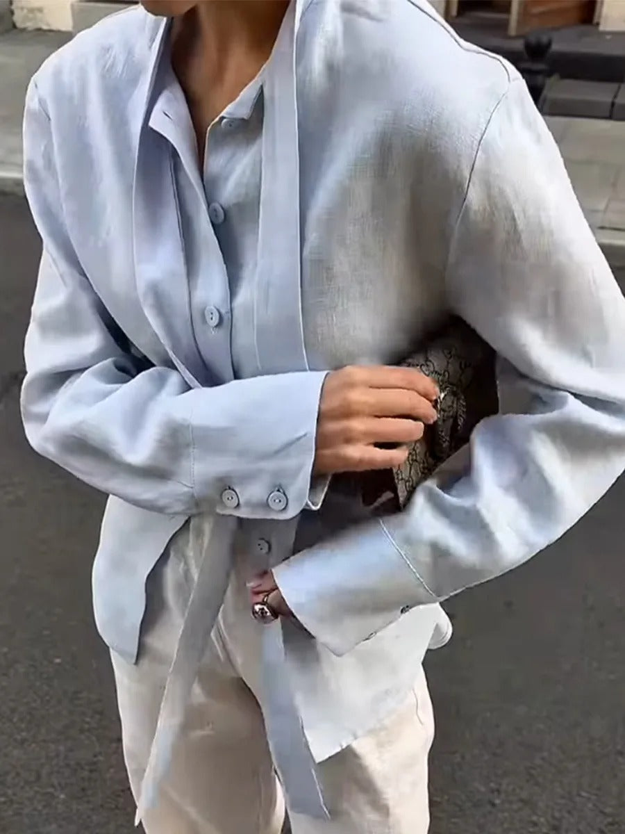 Powder blue tie-waist blouse worn, close view of the placket buttons and cuff