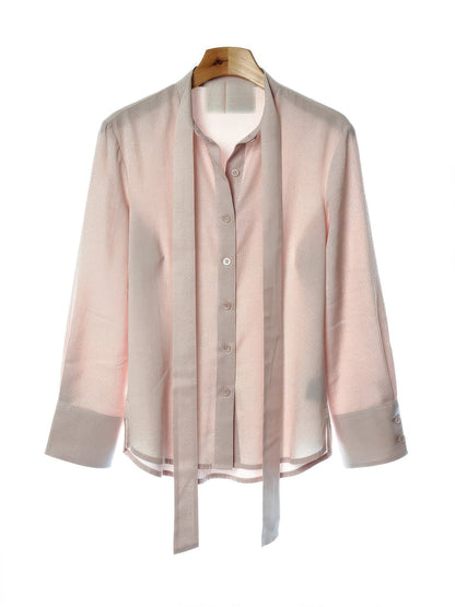 Shell pink tie-waist blouse on a hanger, front view with the ribbon sash hanging loose