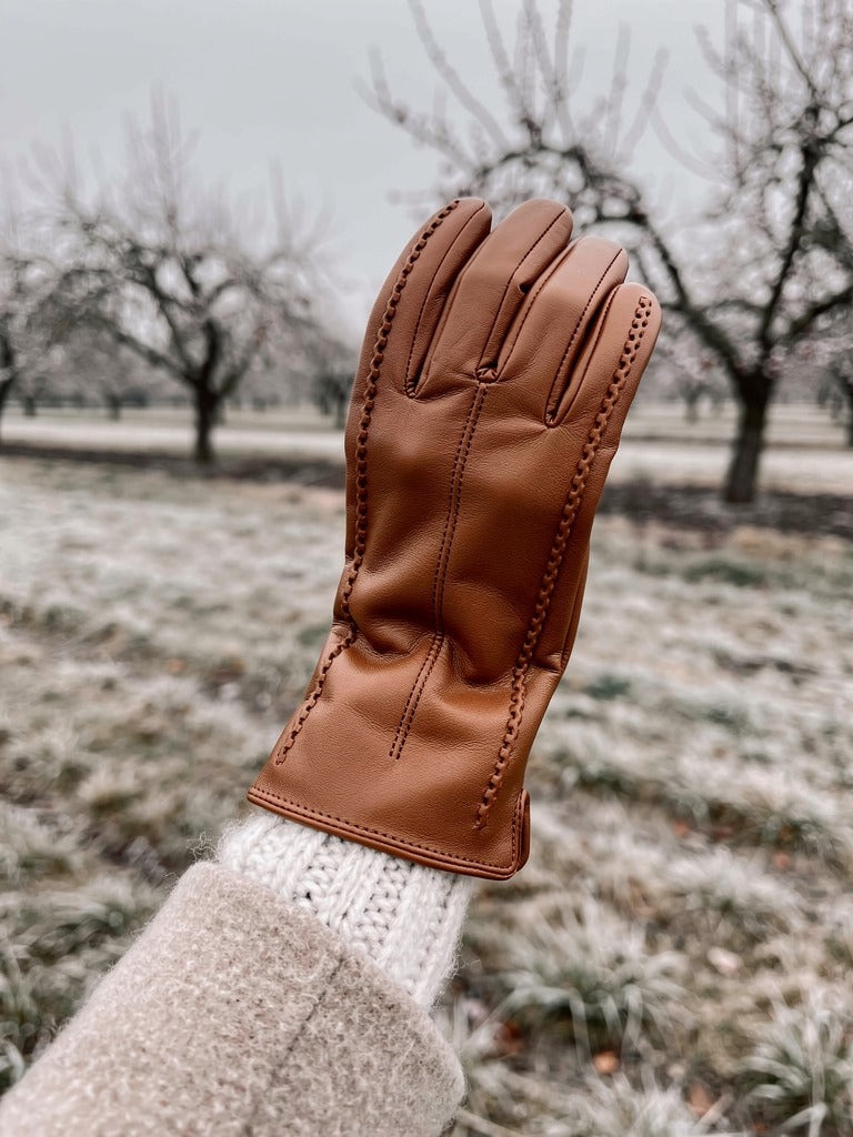 Cognac touch screen glove worn in a winter orchard
