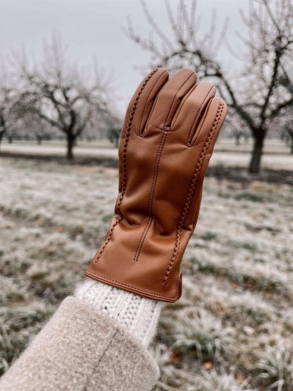 Cognac touch screen glove worn in a winter orchard