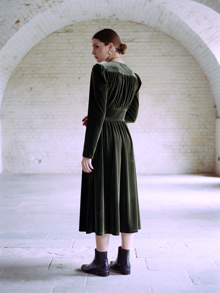 Velvet midi dress in Loden Green seen from the back, gathered upper back and full skirt