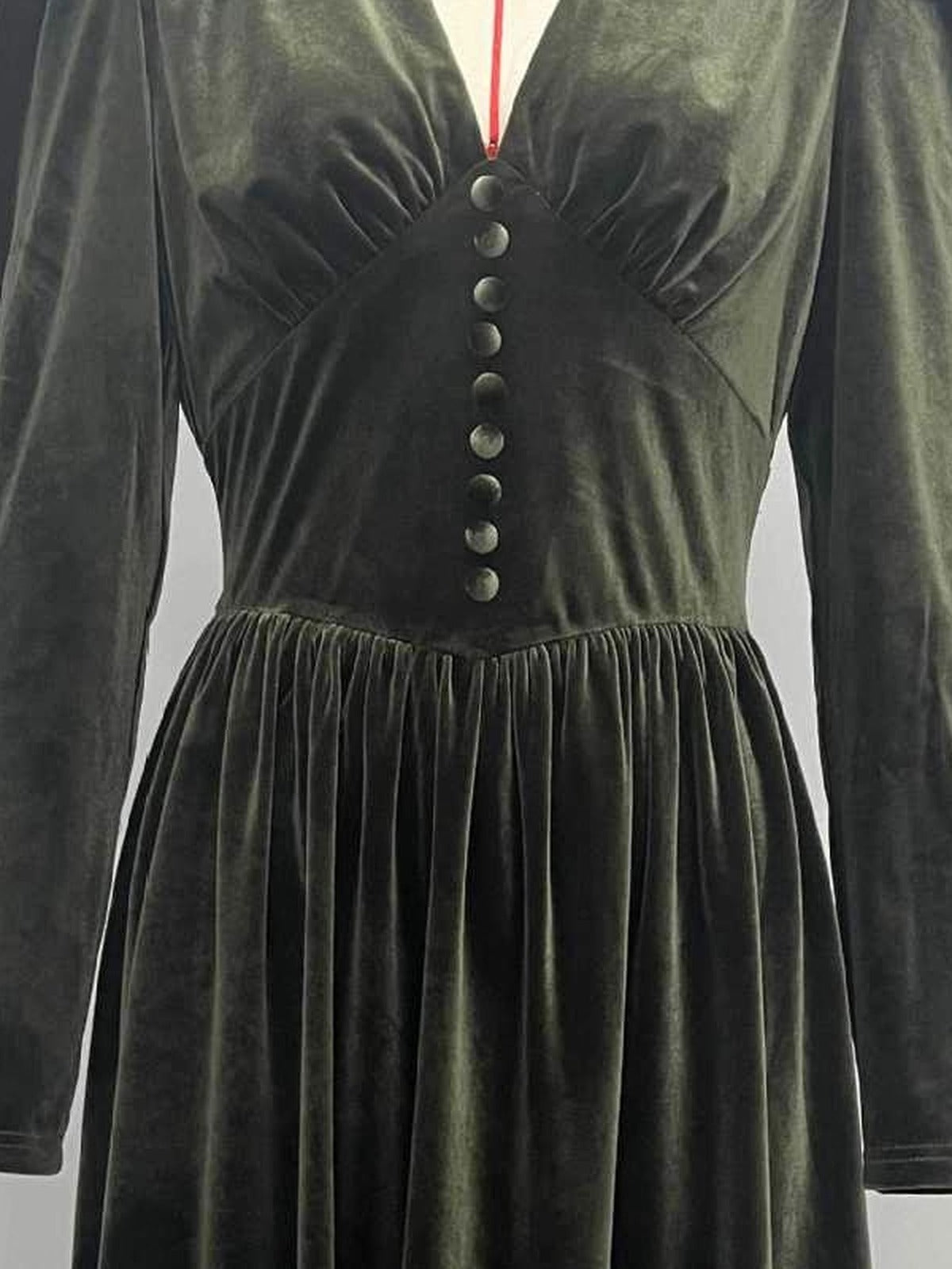 Nine covered buttons down the shaped centre panel of the velvet midi dress