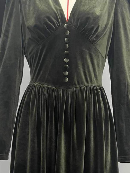 Nine covered buttons down the shaped centre panel of the velvet midi dress