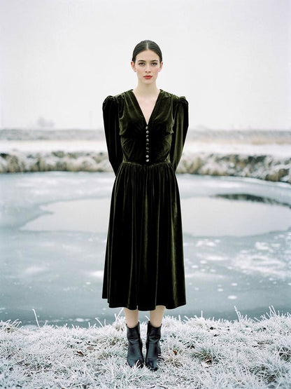 Velvet midi dress in Loden Green, worn by a frozen park pond in winter