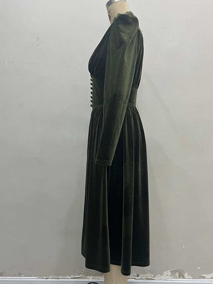 Side view of the velvet midi dress showing the fitted waist and the full gathered skirt