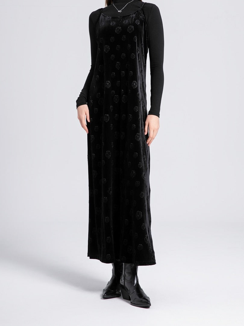 Black velvet slip dress worn full length over a fine black roll neck