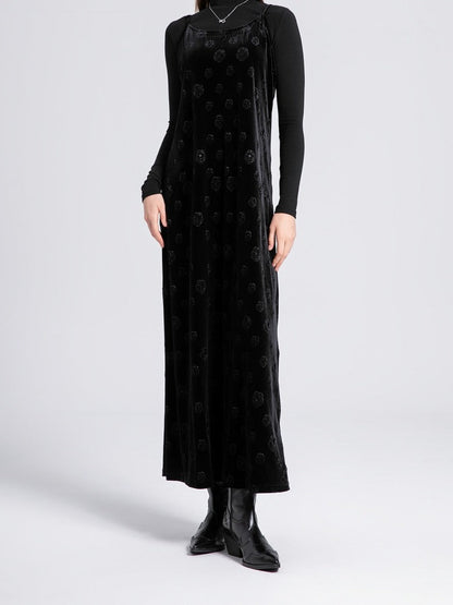 Black velvet slip dress worn full length over a fine black roll neck