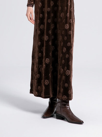 Skirt of the Havana velvet slip dress worn, showing the rose motif and the maxi hem