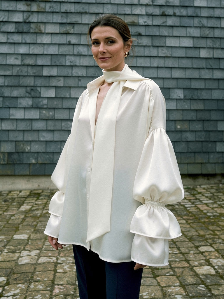 Womens white satin blouse worn oversized with a matching tie scarf and puff sleeves