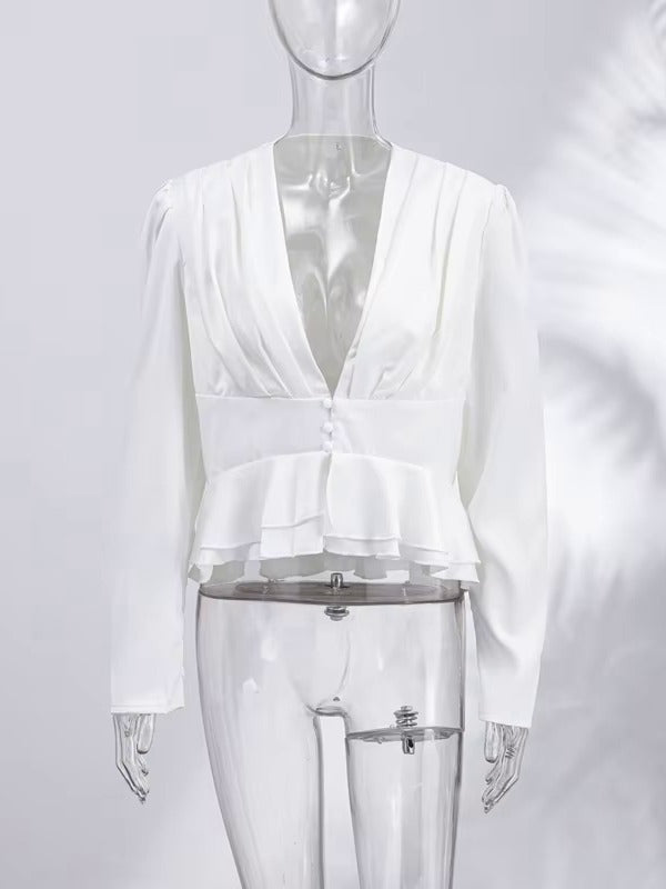 Womens white peplum blouse seen from the front with its pleated deep V neck