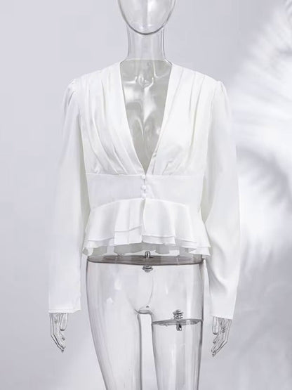 Womens white peplum blouse seen from the front with its pleated deep V neck