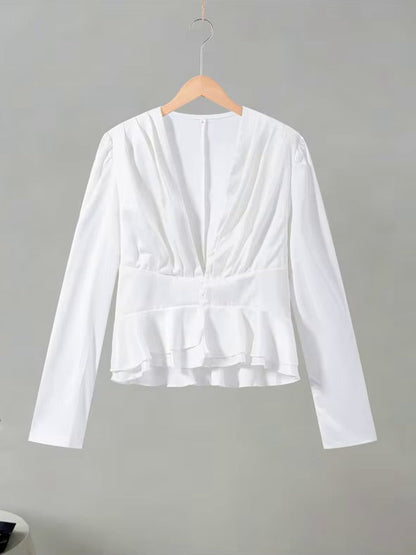White peplum blouse on a hanger showing the full shape and the double frill hem
