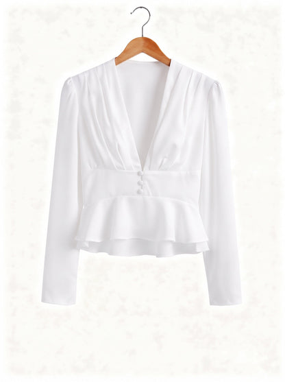 White peplum blouse on a hanger showing the deep V neck and the double peplum frill