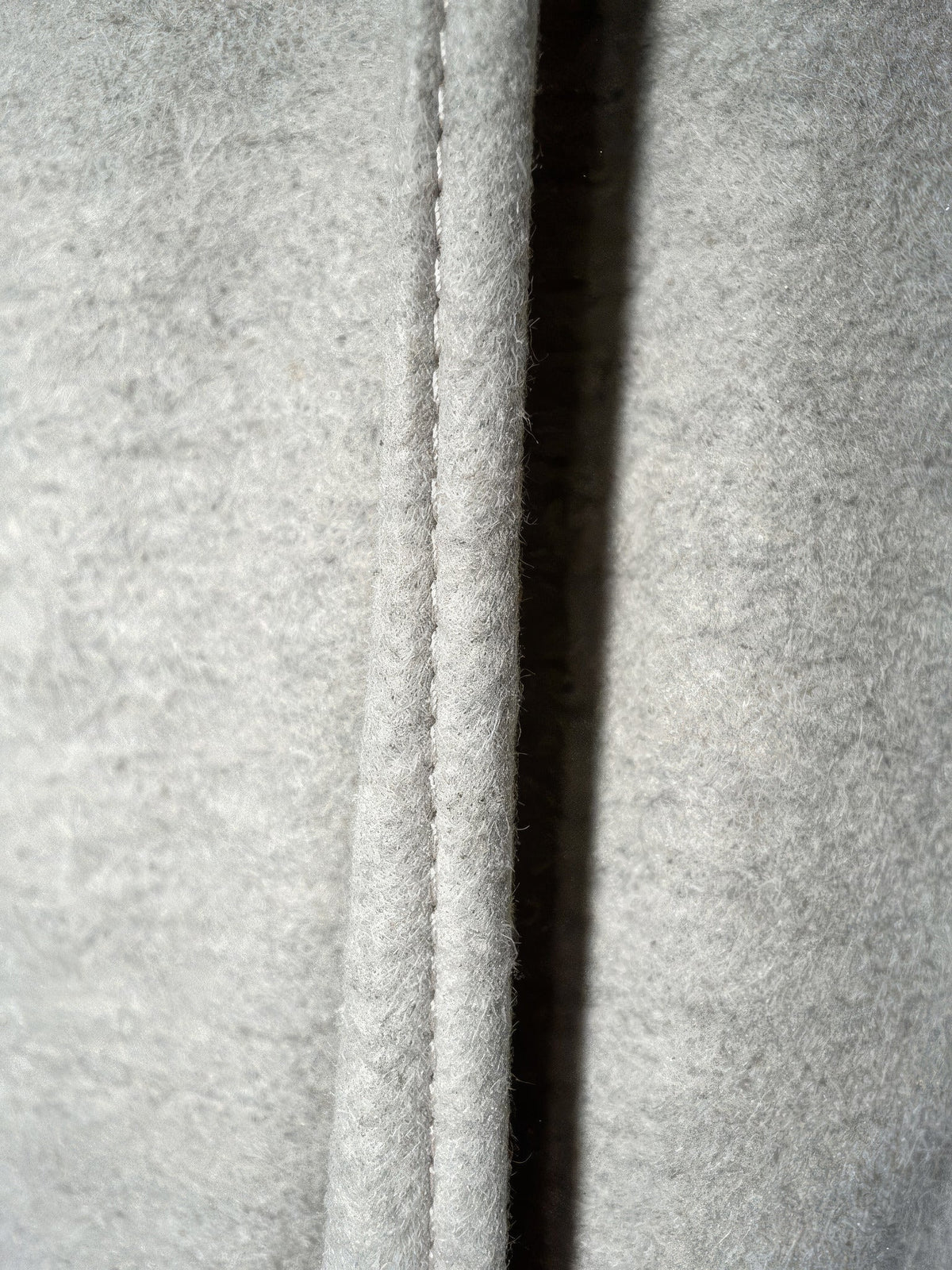 Close-up of the warm brushed cloth of the putty wide-leg trousers