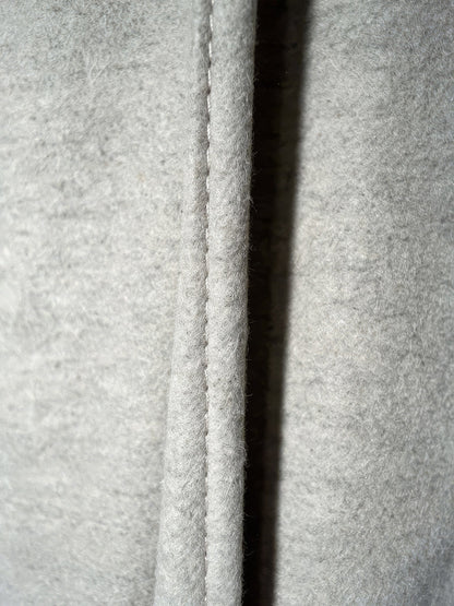 Close-up of the warm brushed cloth of the putty wide-leg trousers