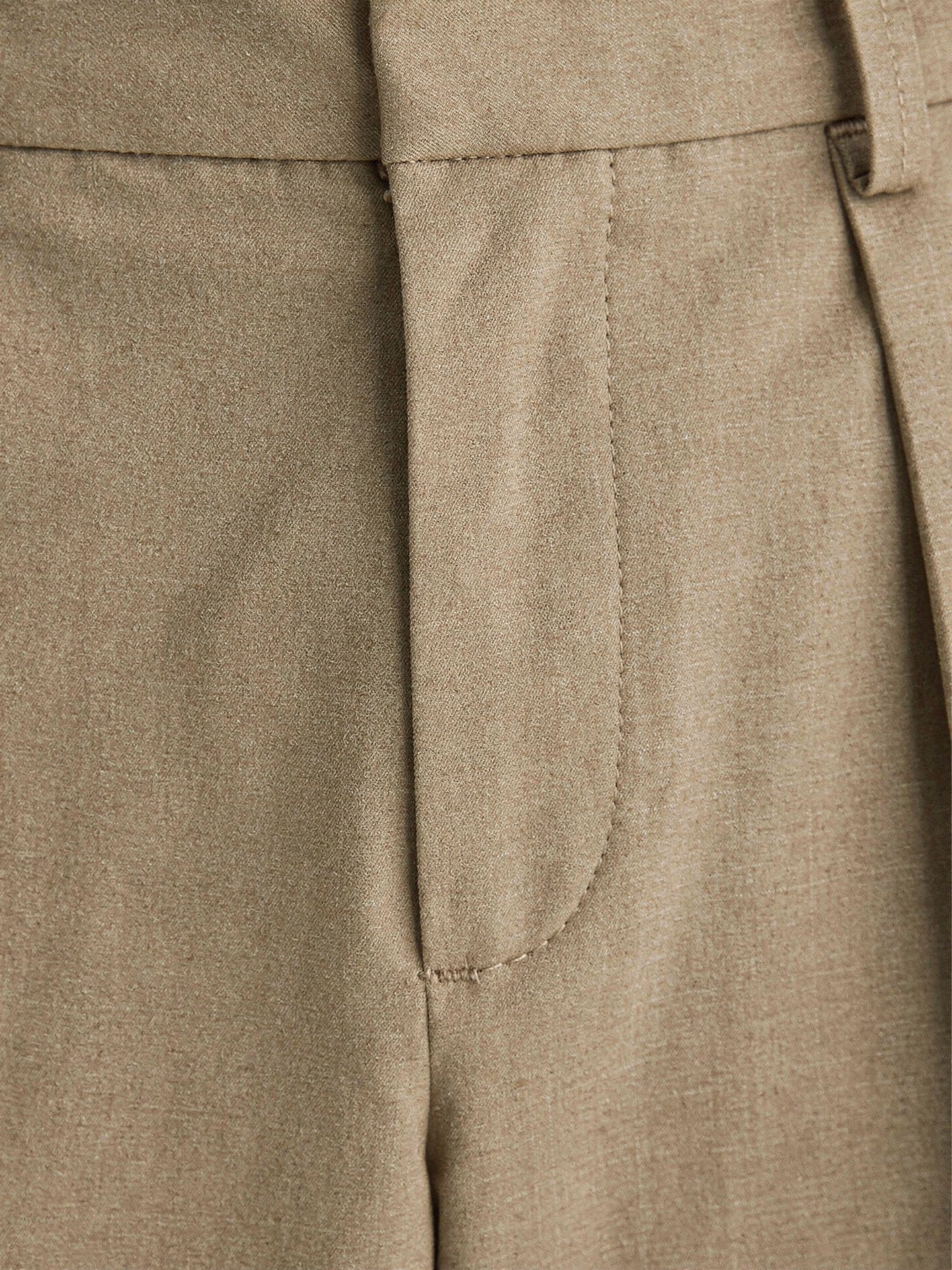 Close-up of the matte tailored weave and pressed pleat of the Winsley trousers in taupe