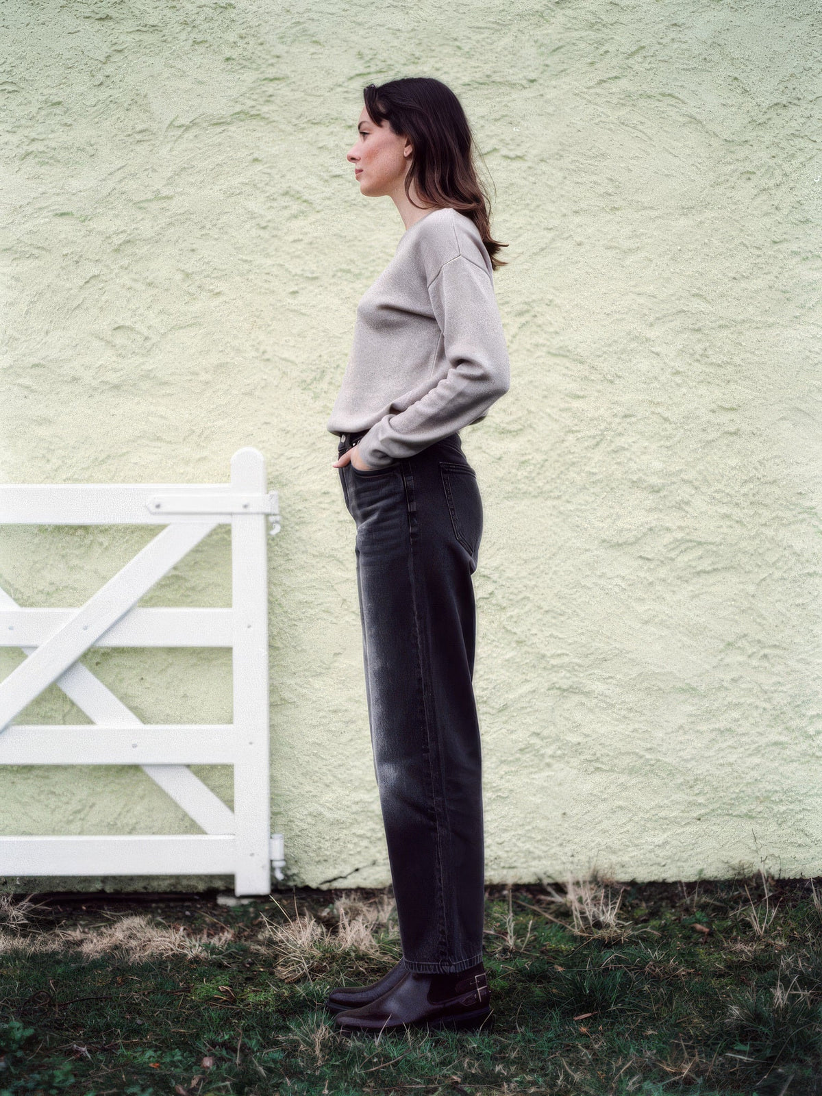 Black jeans in Faded Black seen from the side, straight leg falling full length
