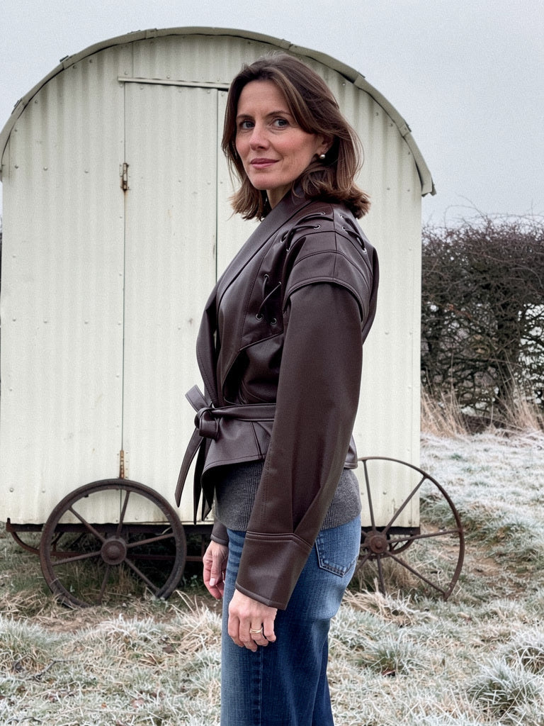 Side view of the Hazleton brown faux leather jacket showing the laced shoulder detail