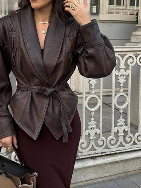 The Hazleton brown faux leather jacket worn belted over jeans in the street