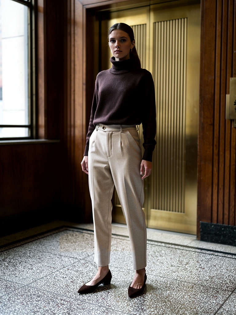 Womens high-waisted tapered trousers in Oat herringbone twill, worn with a dark roll-neck
