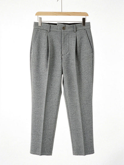Pewter herringbone twill high-waisted tapered trousers on a hanger, front view