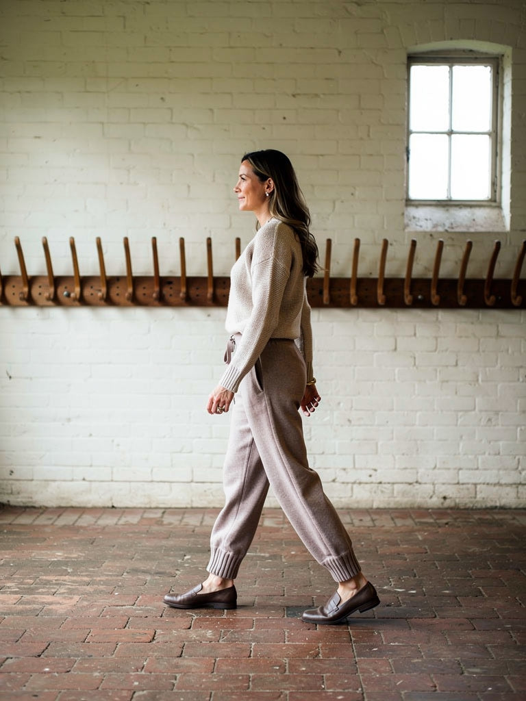 Womens knitted merino wool trousers in Mushroom, worn in profile