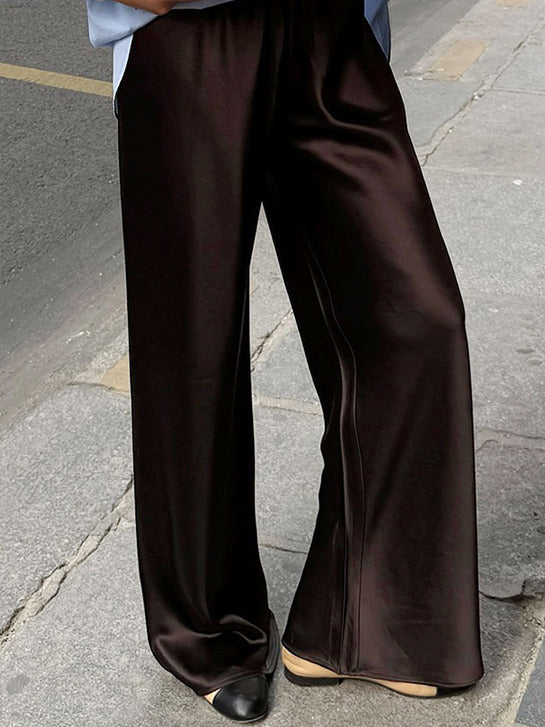 Chocolate satin trousers worn full length, a real photograph of the garment