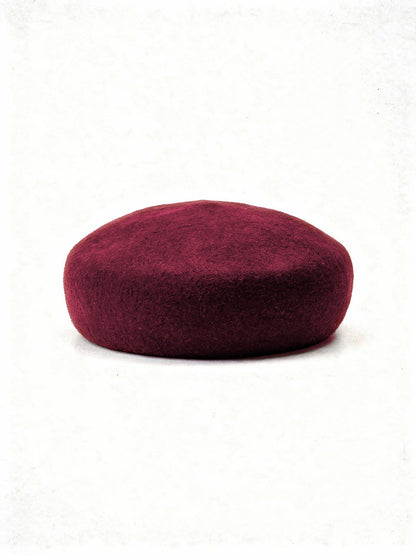 Loganberry wool beret with a seamless felt domed crown, side view
