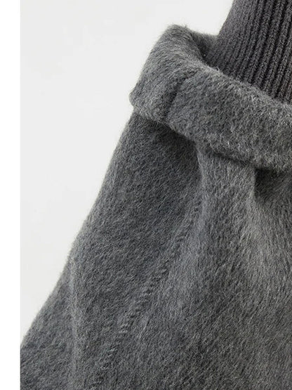 Sleeve of the grey wool coat showing the hand finished saddle stitch and the plain cut cuff
