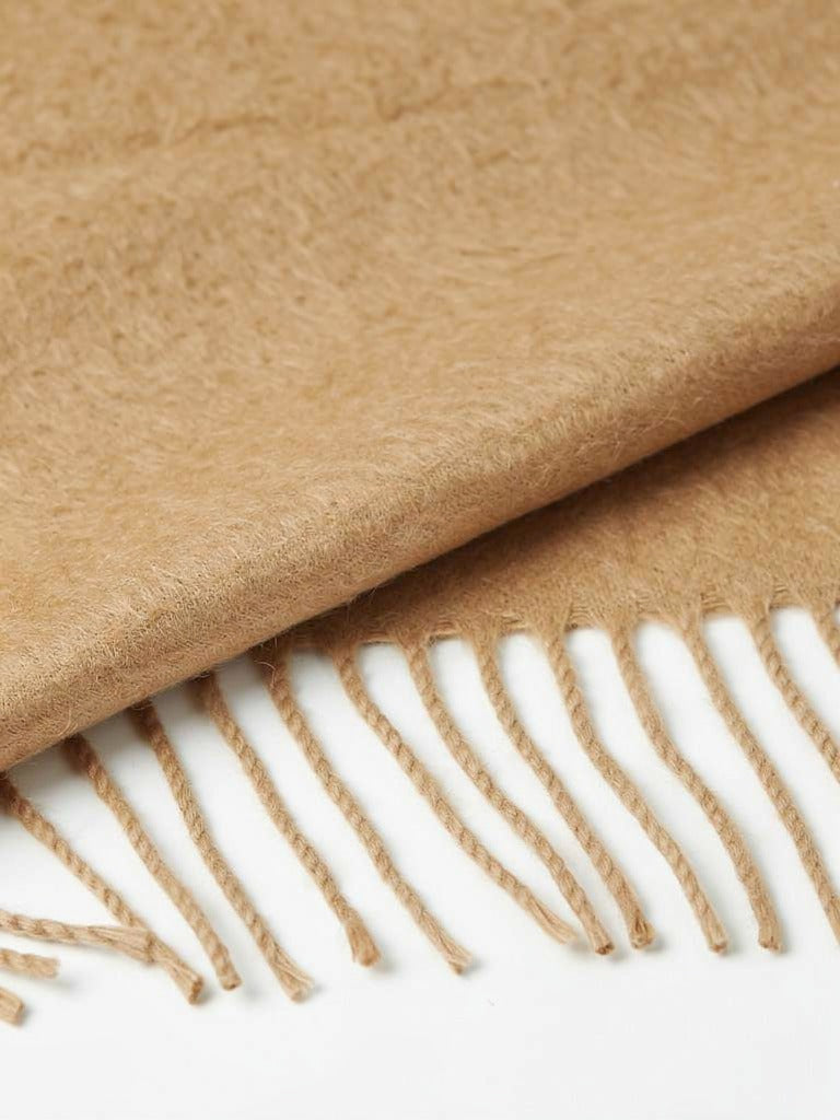 Close-up of the brushed wool cloth and the twisted cord tassels of the pashmina shawl