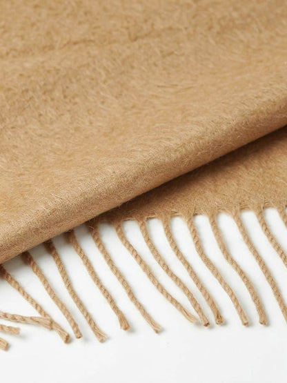 Close-up of the brushed wool cloth and the twisted cord tassels of the pashmina shawl