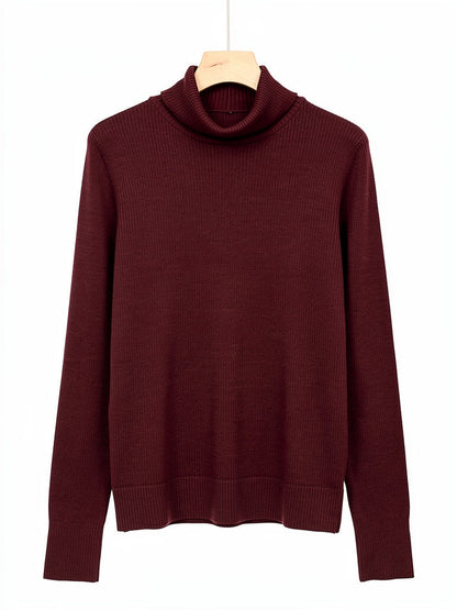 Burgundy wool roll neck jumper on a hanger, showing the fine rib, folded roll neck and deep ribbed cuffs